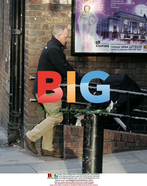 Les Dennis Arrives with Baby at Liverpool Theatre