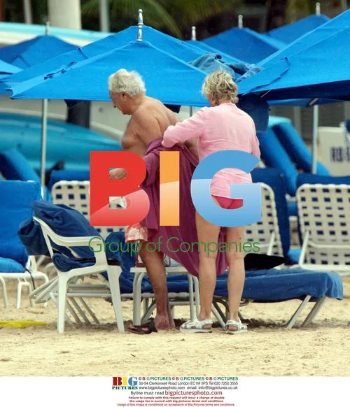 Michael Winner relaxes on Sandy Lane beach