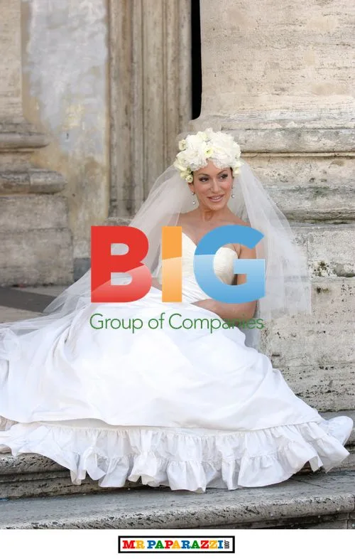 Nancy Dell' Olio Poses in Wedding Dresses
