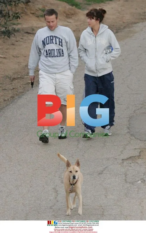 Kate Walsh and hubby Alex Young walk dog