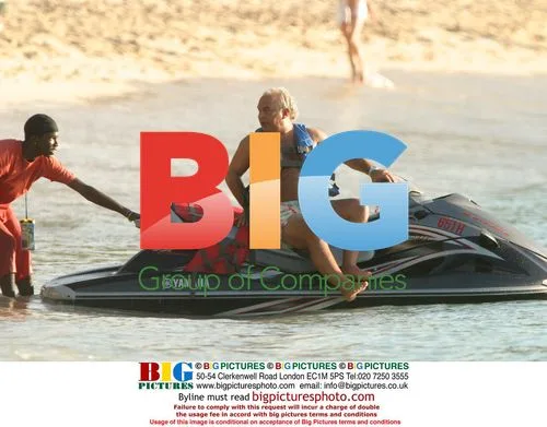 Simon Cowell and Philip Green on jet ski in Barbados