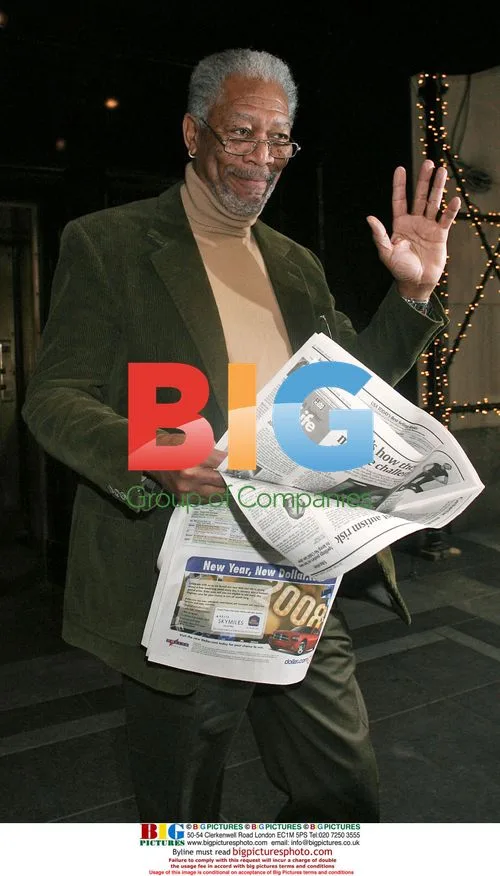 Morgan Freeman leaves hotel with newspaper