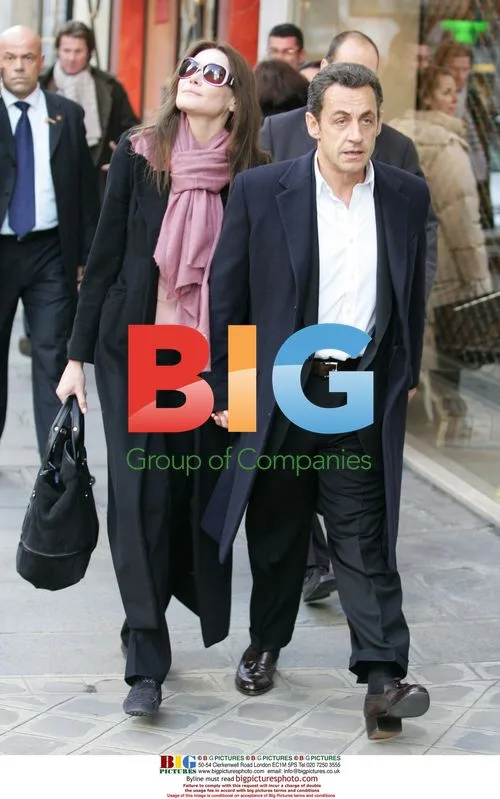 Sarkozy and Bruni Exit Hotel