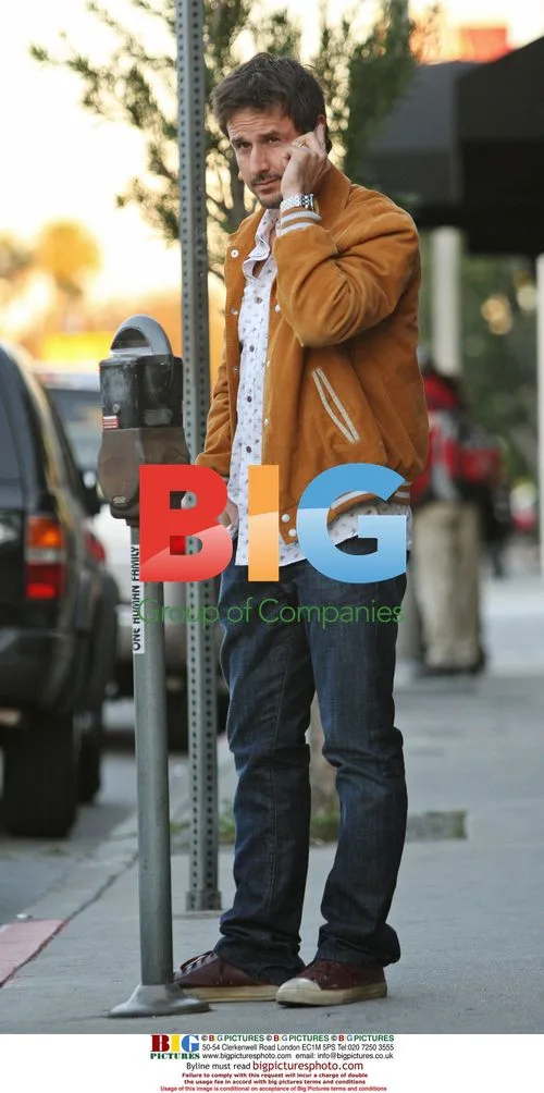 David Arquette chats on phone after visit