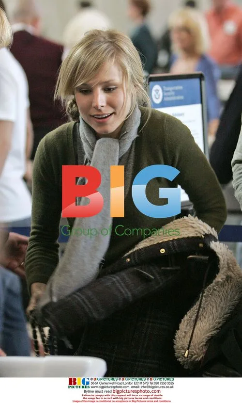 Kristen Bell departs LAX with male friend