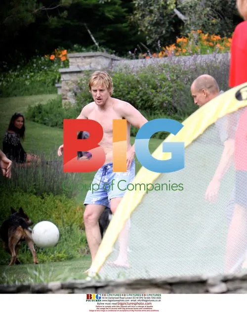 Owen Wilson and Woody Harrelson play football