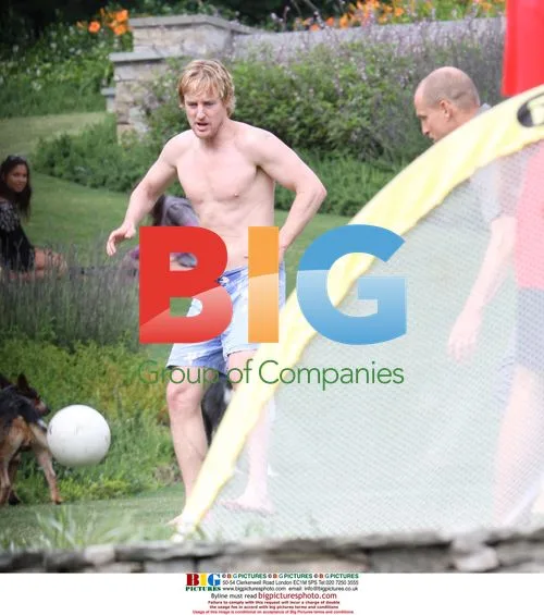 Owen Wilson and Woody Harrelson play football