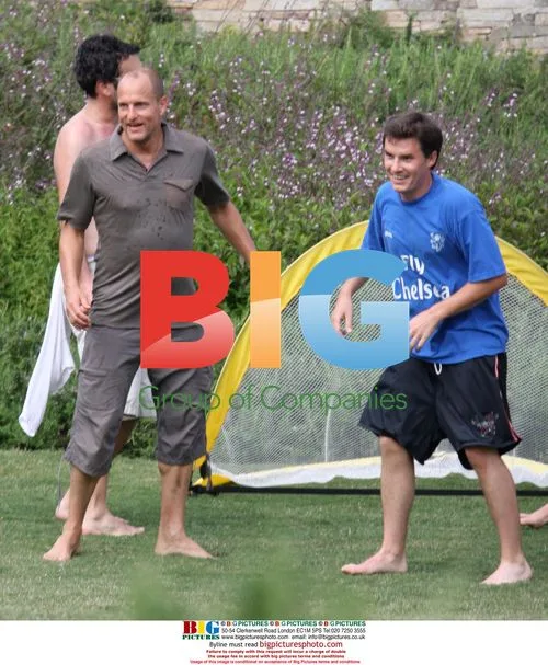 Owen Wilson and Woody Harrelson play football