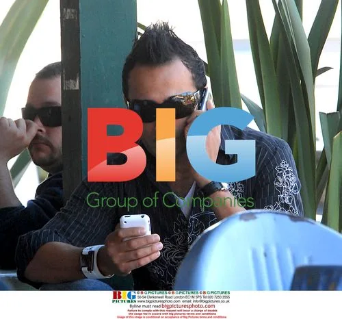Adnan Ghalib passes time in Malibu with two cell phones