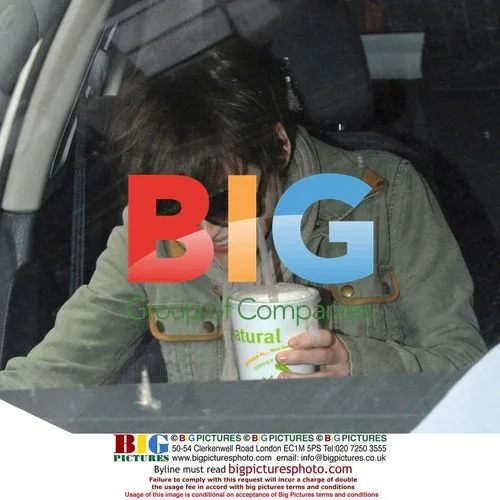 Winona Ryder leaves Soho store, hides behind cup