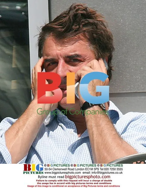 Chris Noth reads newspaper at coffee shop
