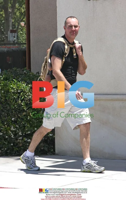 Arnold Vosloo takes newborn on stroll in backpack