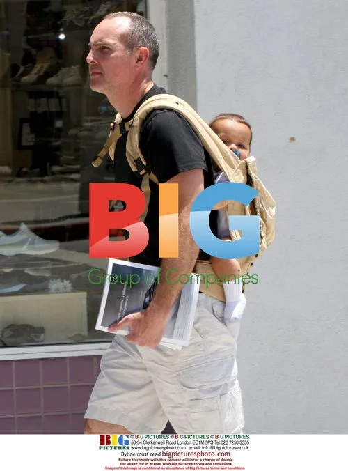 Arnold Vosloo strolls with baby in backpack