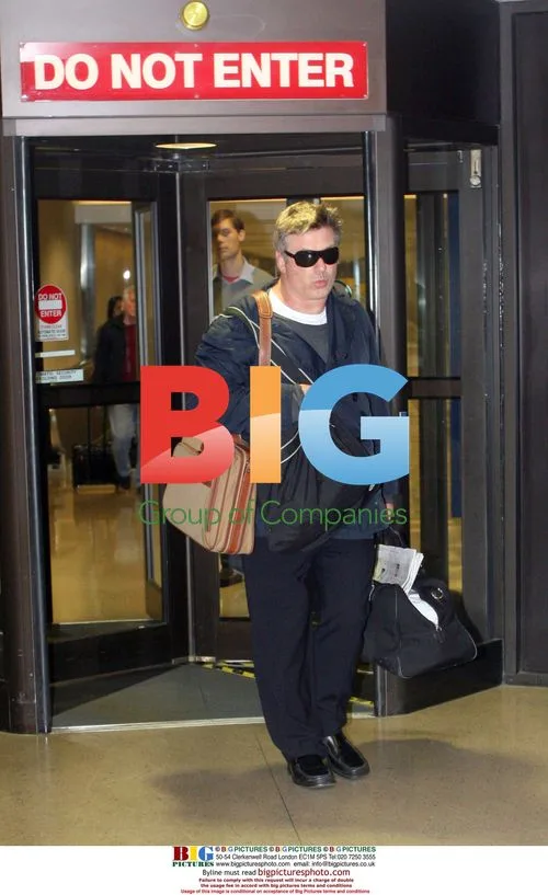 Alec Baldwin at LAX with luggage