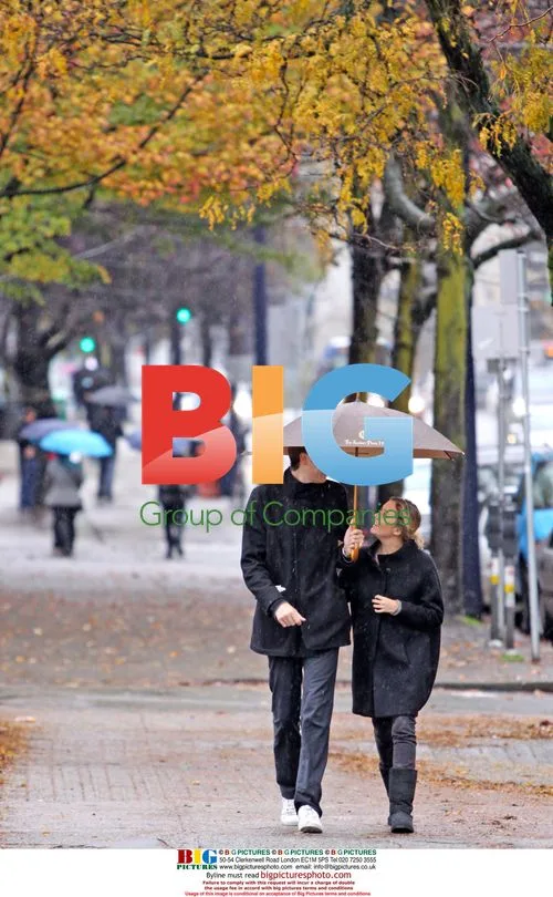 Stephen Merchant and girlfriend walk in rain