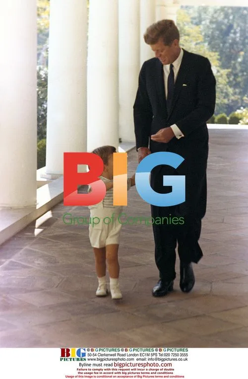 JFK and son walk in White House