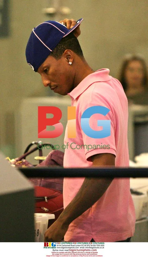 Pharrell Williams shows boxer shorts at LAX