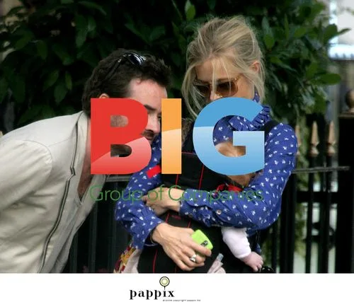 Laura Bailey, Eric Fellner, and baby in London