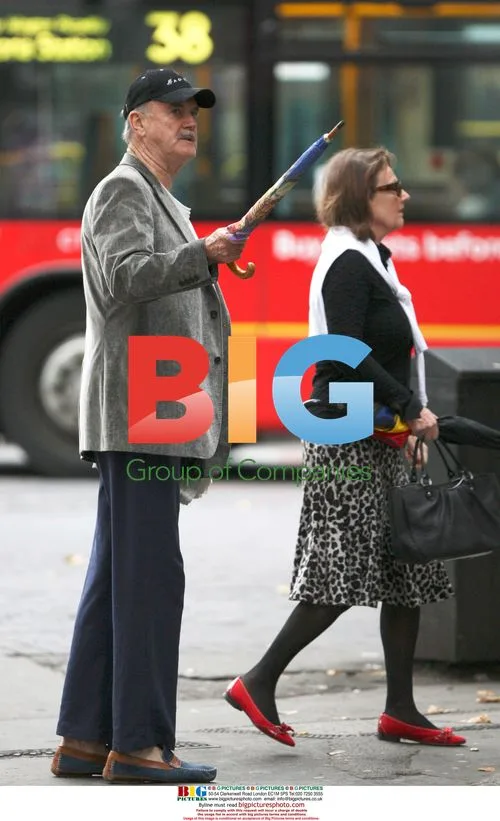 John Cleese with umbrella in London