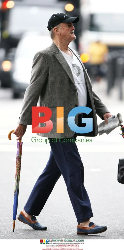 John Cleese with umbrella in London