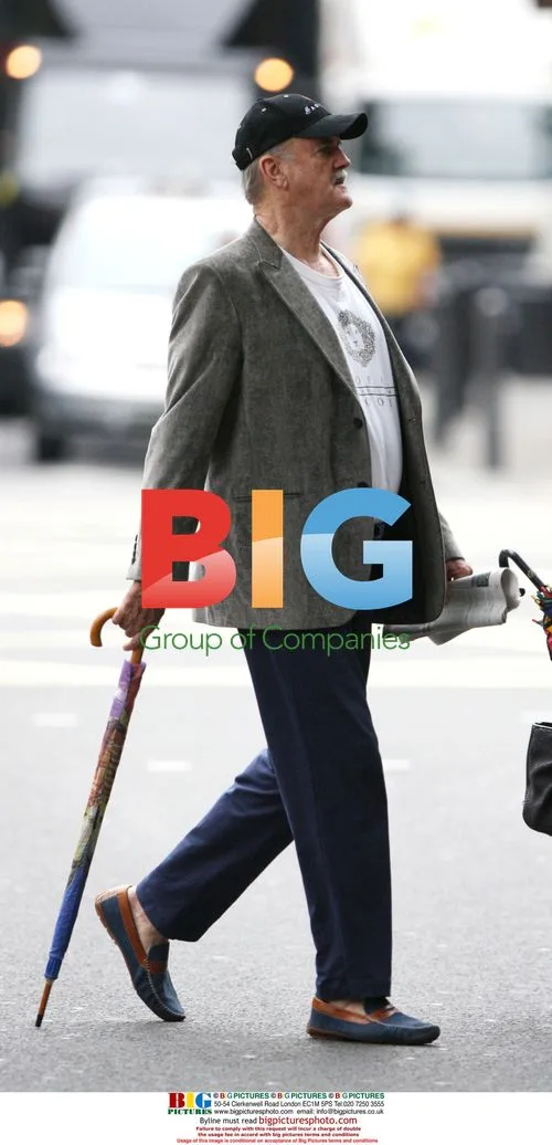 John Cleese with umbrella in London