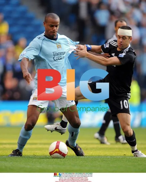 Joe Cole and Vincent Kompany in Premier League match