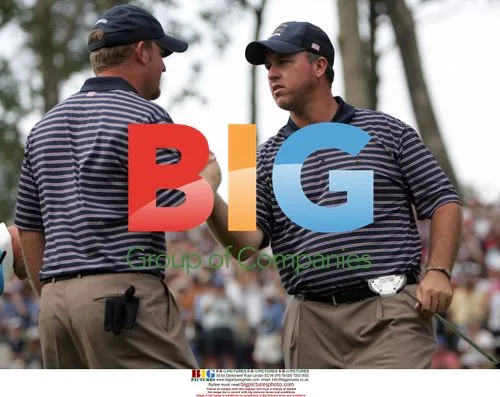 Weekley congratulated by Holmes at Ryder Cup