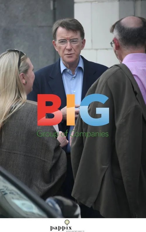 Peter Mandelson checks phone with friends