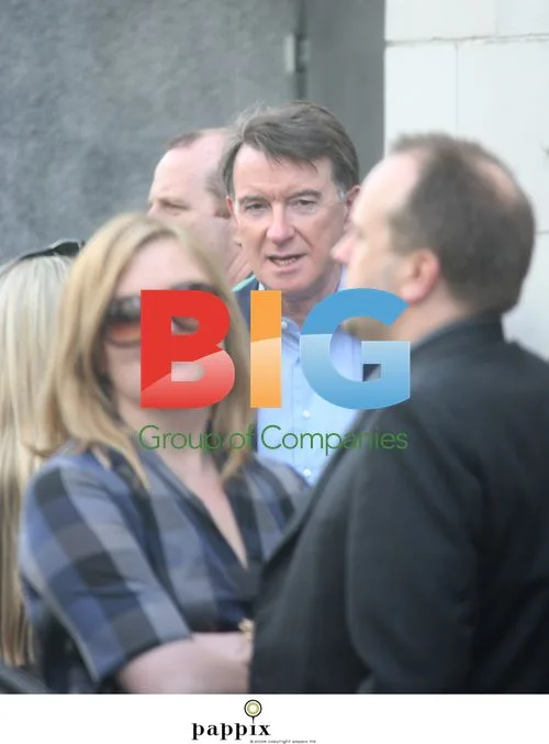Peter Mandelson checks phone with friends