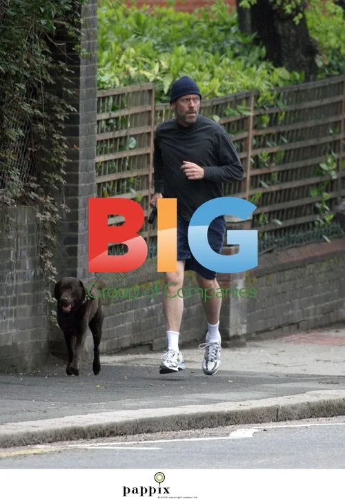 Hugh Laurie jogging with dog in London