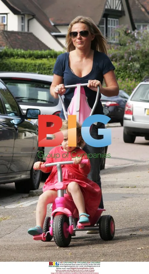 Geri Halliwell adjusts bra while out with daughter