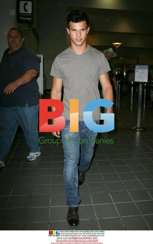 Taylor Lautner and father arrive at LAX