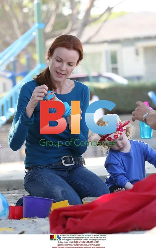 Marcia Cross plays with twins in park