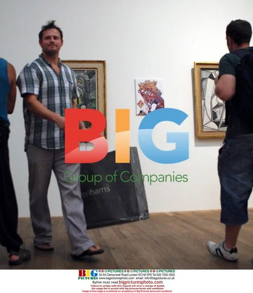 Graffiti artist "Don" hangs work in Tate Modern