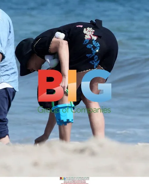 Linda Evangelista and son on beach