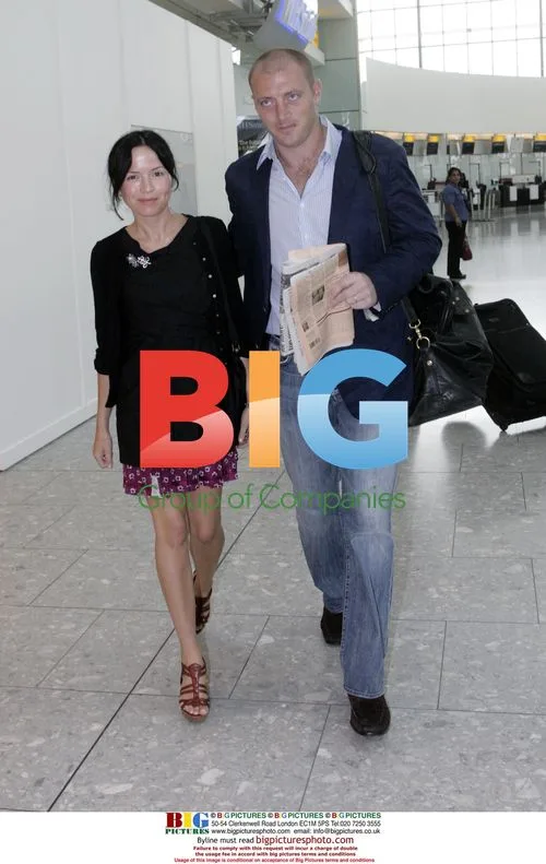 Andrea Corr and husband Brett Desmond at Heathrow