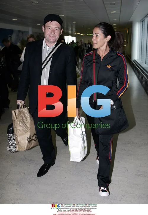 Jimmy White arrives home with girlfriend