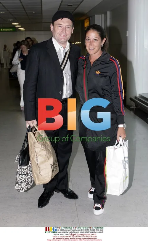 Jimmy White arrives home with girlfriend