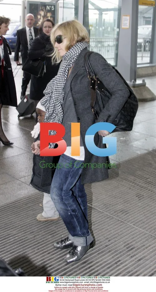 Madonna and adopted daughter Mercy arrive in London