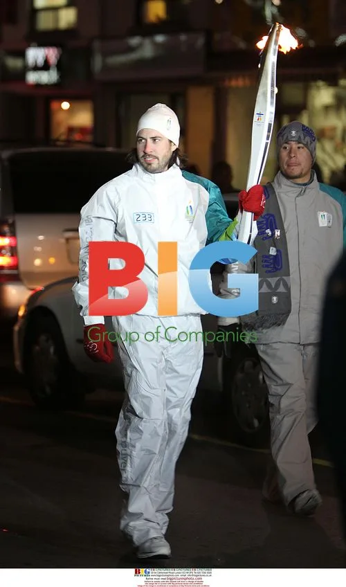 Jason Reitman waits with Olympic torch