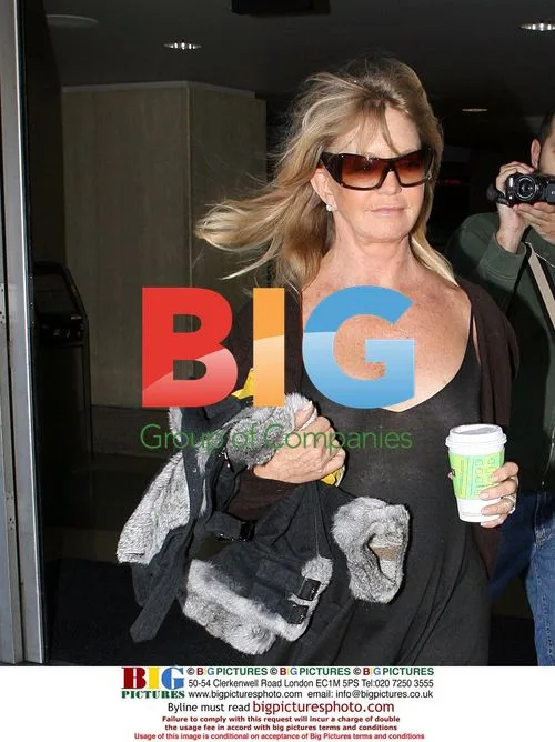 Goldie Hawn Arrives at LAX in Revealing Dress
