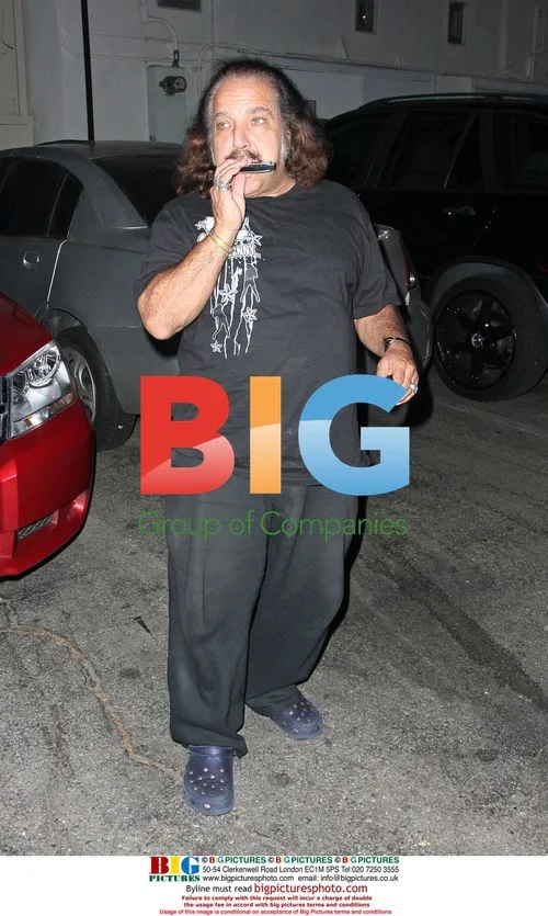 Ron Jeremy plays harmonica in crocs