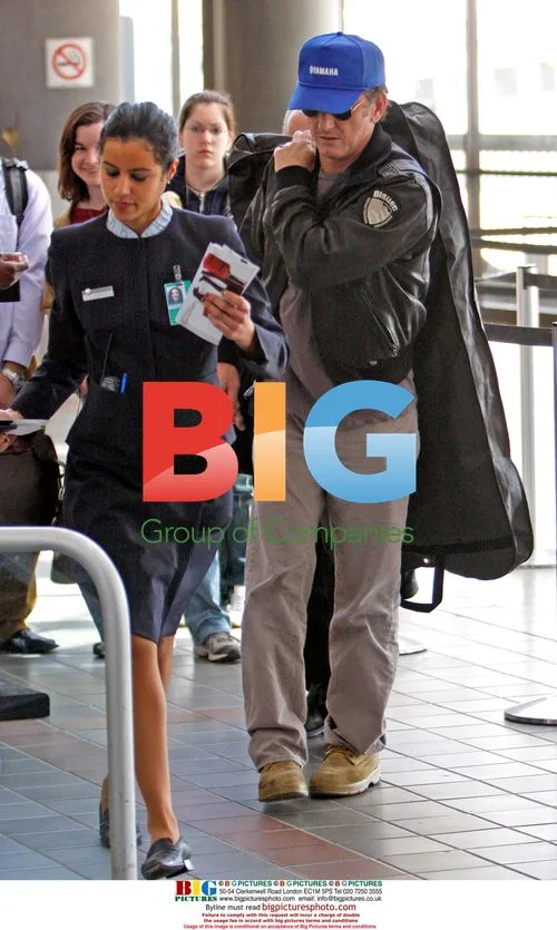 Sean Penn carrying garment bag at LAX