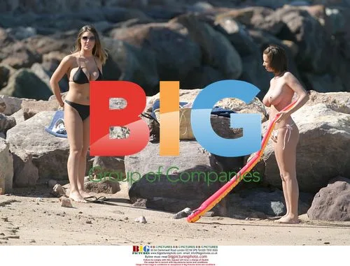 Glamour models Lucy Pinder and Sophie Howard on beach