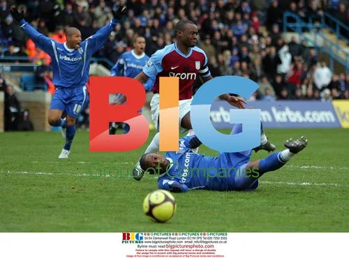 Dennis Oli of Gillingham fouled by Nigel Reo-Coker