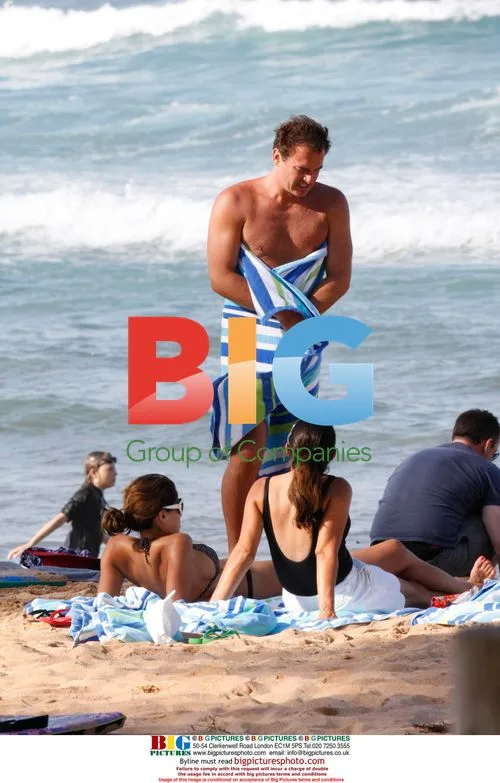Julian McMahon and girlfriend at beach