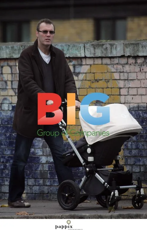 Andrew Morton takes baby for walk in London