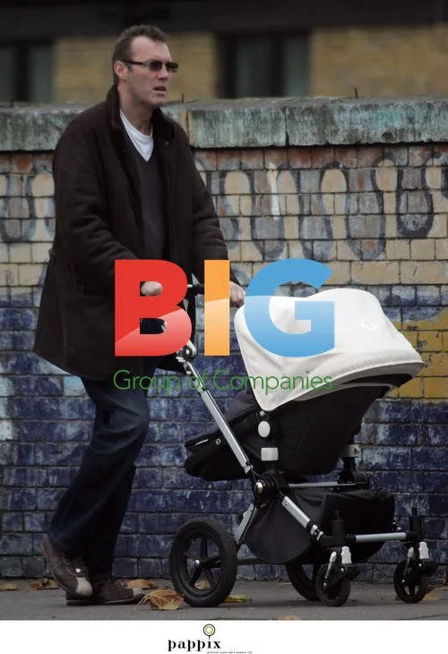 Andrew Morton takes baby for walk in London