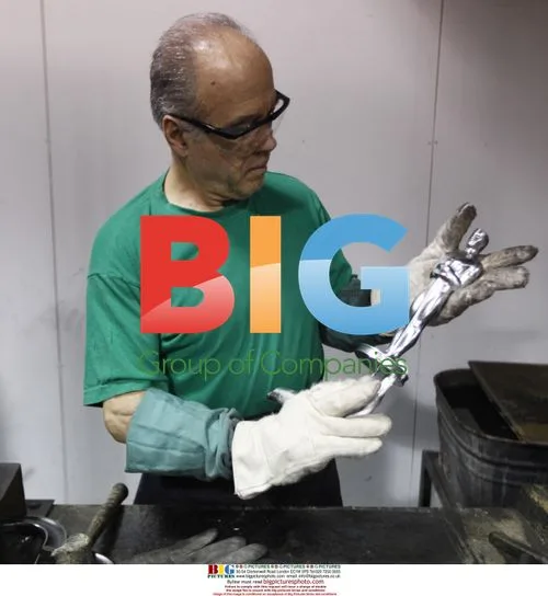 Luis Villalobos inspects Oscar statuette