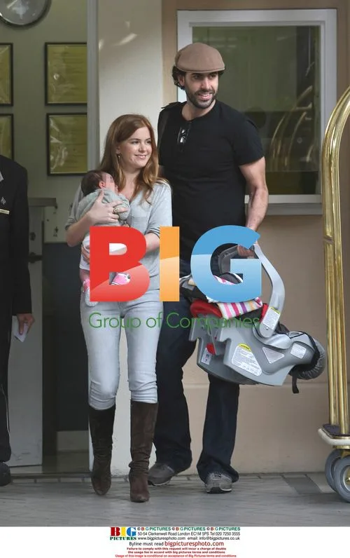 Sacha Baron Cohen and Isla Fisher with baby Olive